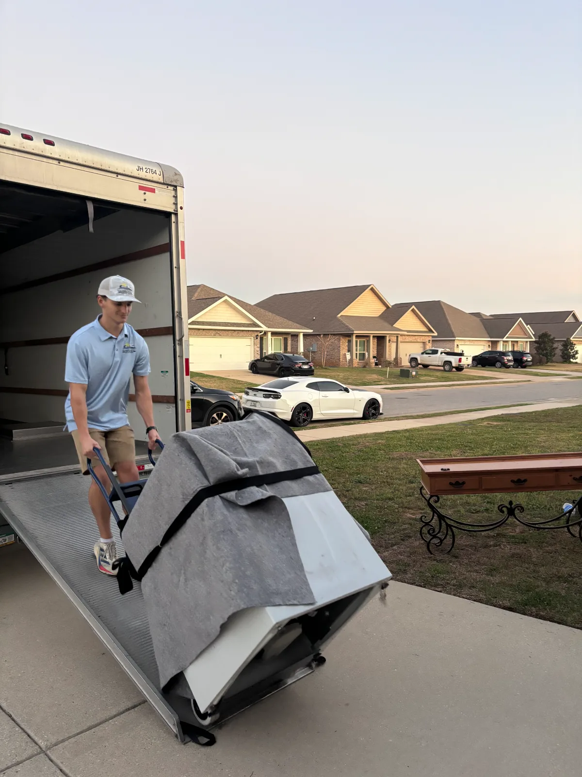Southern Shores Moving crew handling furniture with a dolly during a customer move