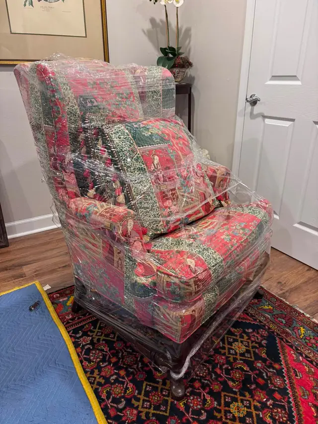 Upholstered armchair shrink-wrapped for the move