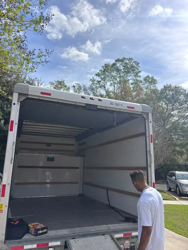 Crew member beside the open moving truck