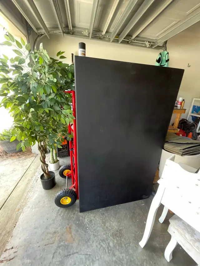 Large padded item secured on a moving dolly