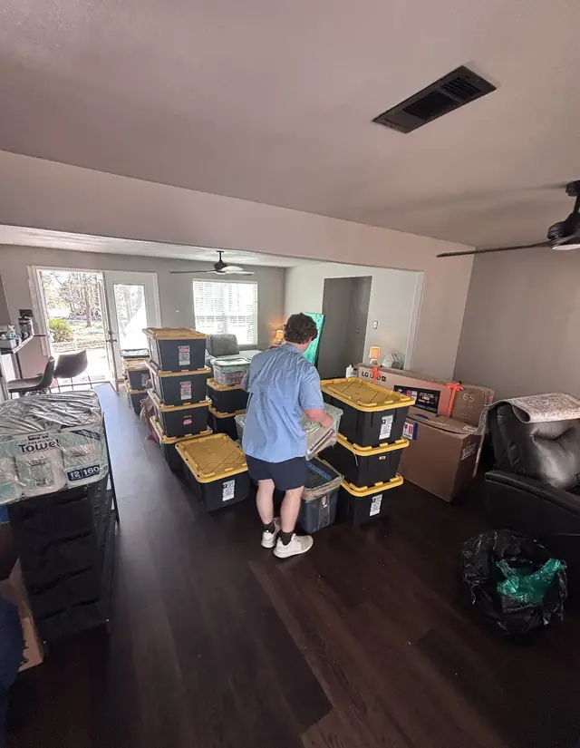 Mover staging storage totes in a living room