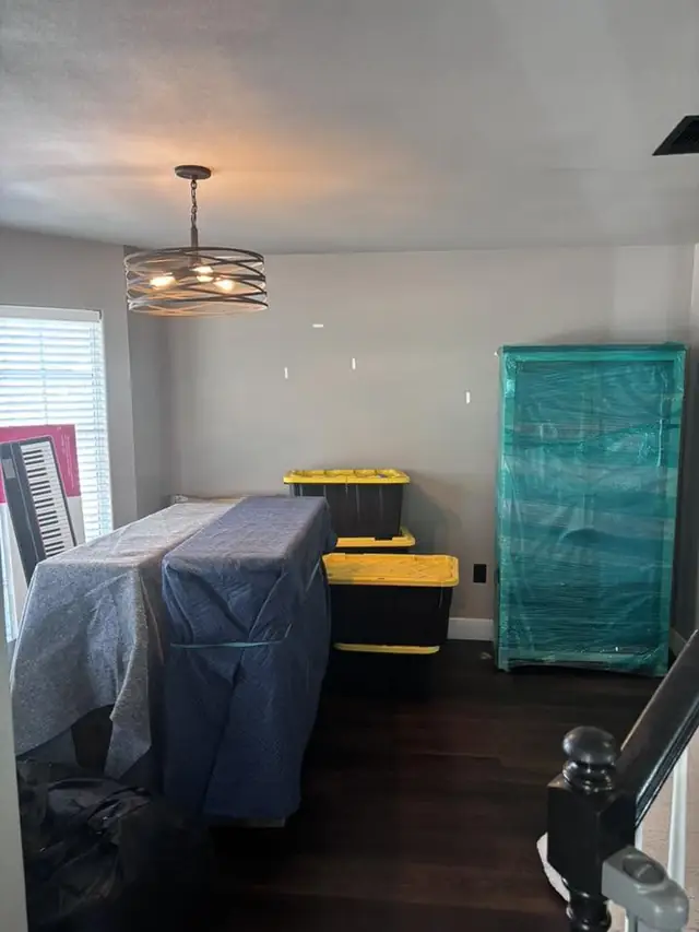 Bedroom with padded furniture and a wrapped cabinet