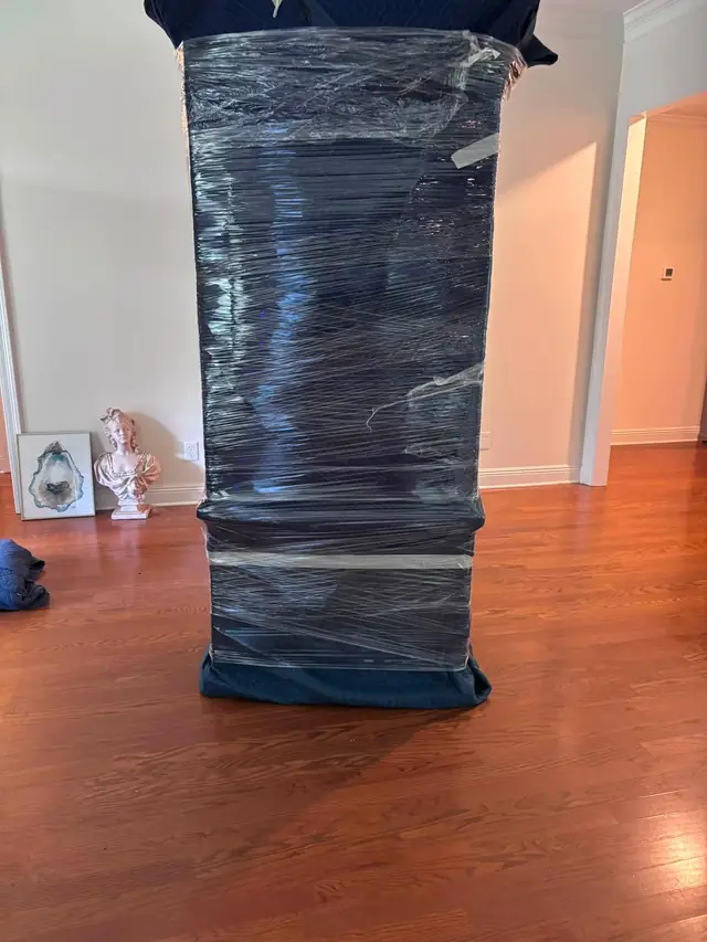 Tall piece of furniture shrink-wrapped and padded