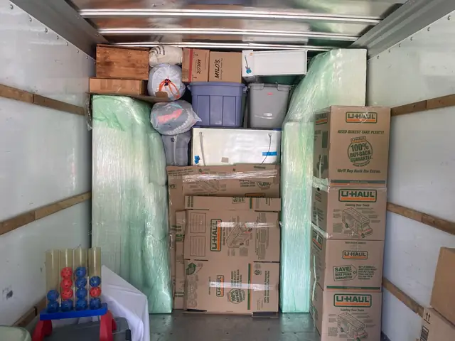 Truck interior with boxes and wrapped furniture