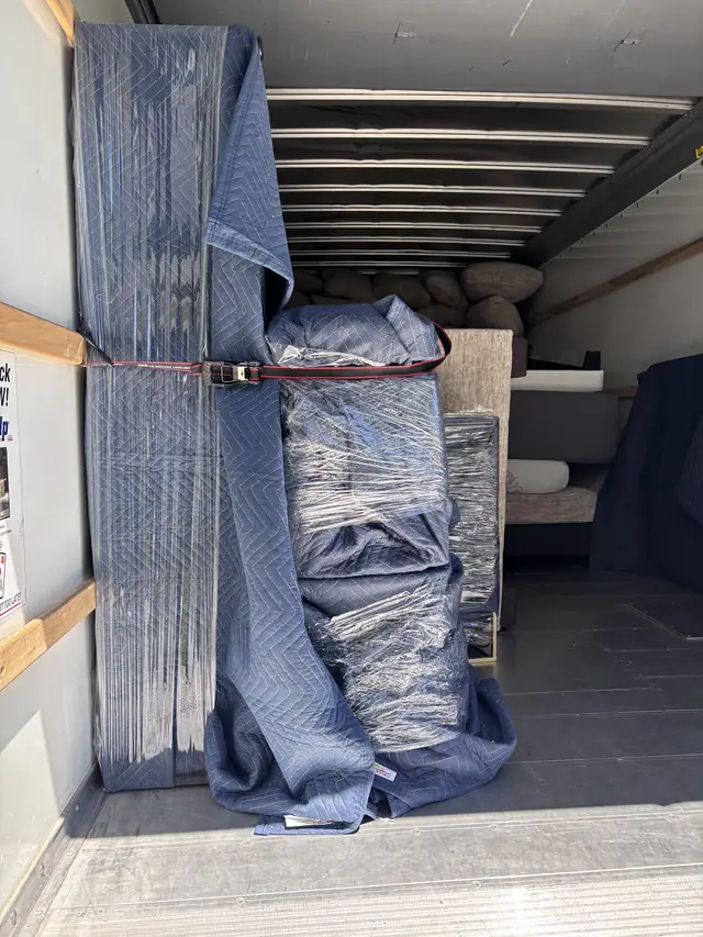 Padded furniture strapped inside the truck