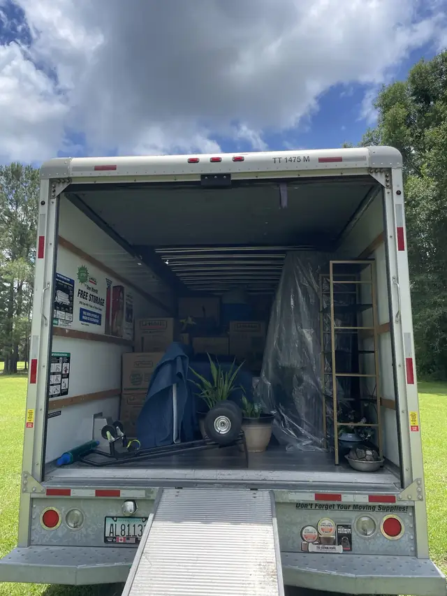 Open box truck with ramp, partly loaded