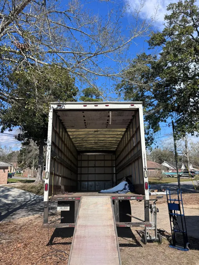 Box truck with ramp down being loaded