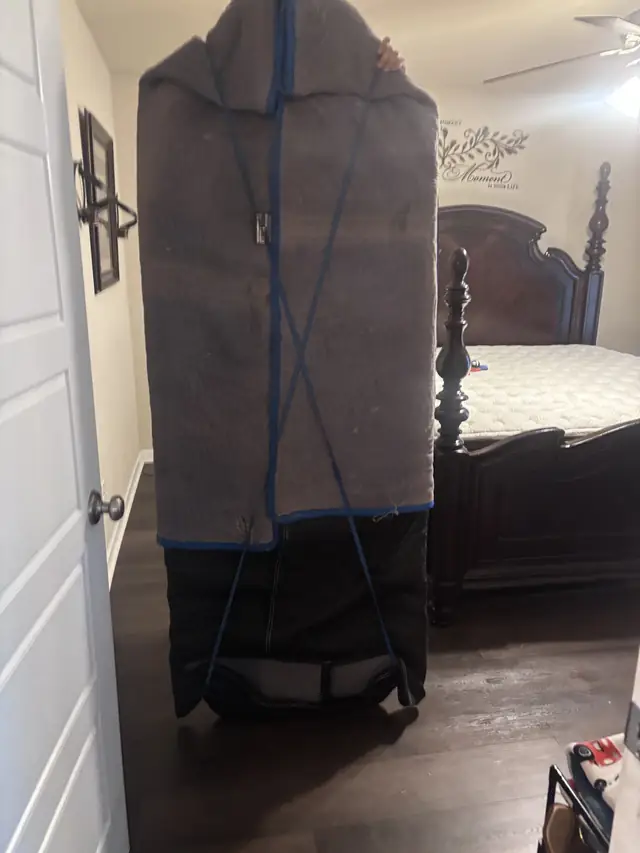 Wardrobe padded with moving blankets in a bedroom